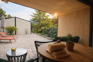 a room with a table and chairs and a patio at Apartments Pri nas in Kobarid
