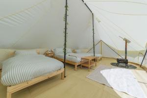 a room with two beds in a tent at Boscoppa Farm-Emperor Tent 1 in St Austell