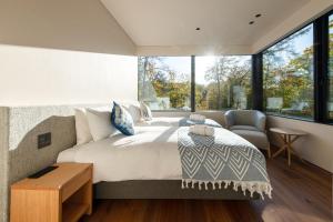 a bedroom with a large bed and a window at Sena 惺絆 in Niseko