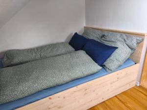 a bed with blue sheets and pillows on it at NEUBEGINN b in Bad Rodach