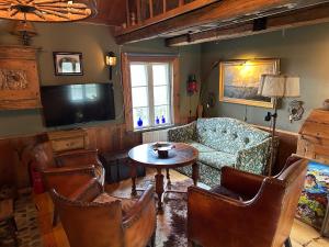 a living room with a couch and a table and a tv at Stuga med havsutsikt in Strömstad +26 photos