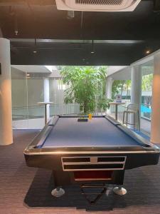 a pool table in the middle of a room at Seaside Living Studio Unit in Maribago