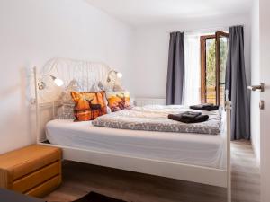 a bedroom with a large white bed with pillows at Gasthof Barlida in Lainach