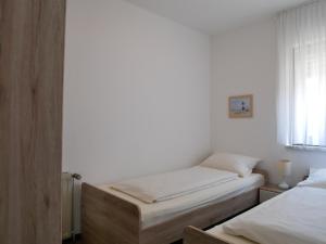 a bedroom with two beds and a window at Haus Gertrud in Carolinensiel
