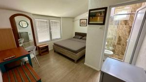 a small bedroom with a bed and a bathroom at Villa Megdani B in Ohrid