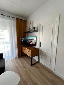 a living room with a flat screen tv on a table at CARPE DIEM DAIMUS in Daimuz