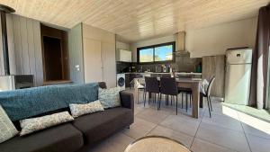 a living room with a couch and a kitchen at Villa Les Galets in Salavas