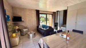 a living room with a couch and a table at Villa Les Galets in Salavas
