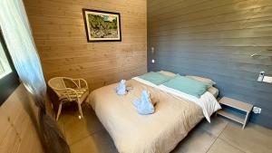 a small bedroom with a bed and a chair at Villa Les Galets in Salavas +28 photos