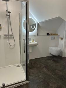 a bathroom with a shower and a sink and a toilet at Roskhill House in Dunvegan +20 photos