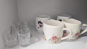 a group of cups and glasses sitting on a counter at Pine-tree stay Mini in Samgong +26 photos