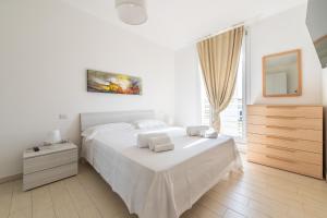 a bedroom with a white bed with two towels on it at Central Terrace, Pula in Pula