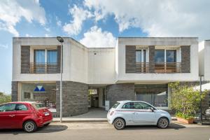 two cars parked in front of a house at Central Terrace, Pula in Pula