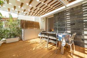 a patio with a table and chairs and a brick wall at Central Terrace, Pula in Pula