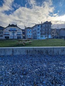 a picnic table in a park with buildings in the background at La parenthèse Lémantine - Studio 2 in Neuvecelle