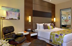 a hotel room with a bed and a desk and a chair at Fortune Park Dahej - Member ITC Hotels' Group in Dahej +30 photos