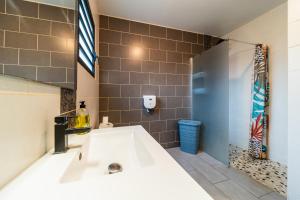a bathroom with a large white bath tub at La Mezina in Saint-Joseph +4 photos