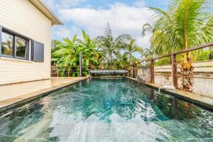 a swimming pool next to a house at La Mezina in Saint-Joseph