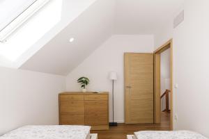 a bedroom with two beds and a wooden cabinet at Vila Šenčur in Šenčur +33 photos