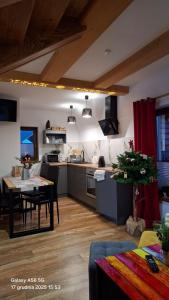 a large kitchen with a table and a dining room at Domek u Bizioma in Murzasichle