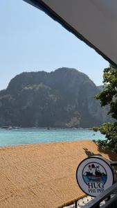 a view of a beach with a mountain in the background at HUG PHIPHI Resort in Phi Phi Islands