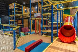 a play area with a slide and a slide at Chalet Casa Quak in Petten