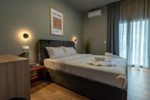 a bedroom with a bed and a large window at Esperia Hotel in Larisa +56 photos