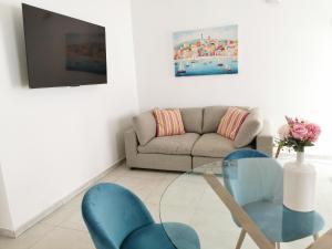 a living room with a couch and a glass table at Domus Luna in Teulada