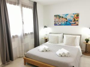 a bedroom with two towels on a bed at Domus Luna in Teulada