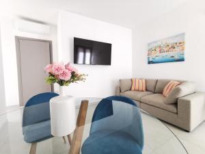 a living room with a couch and a glass table at Domus Luna in Teulada +8 photos