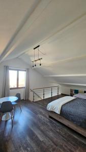 a bedroom with a bed and a table at L'escale Aéro Lyon in Saint-Laurent-de-Mure