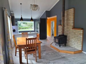 a kitchen and dining room with a table and a stove at Wheel Inn in New Plymouth