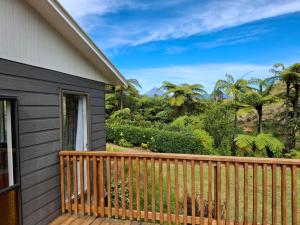 a deck with a view of the mountains at Wheel Inn in New Plymouth +4 photos