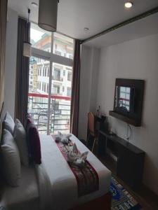 a hotel room with a bed and a window at Hotel Ugyen, Thimphu in Thimphu