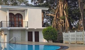 a house with a swimming pool in front of it at Golden Ridge Sigiriya in Dambulla