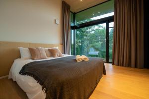 a bedroom with a bed with two towels on it at Hiyoku 飛翼 in Niseko