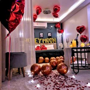 a room with red hearts and balloons on the floor at White Tiger Villa in Goa +5 photos