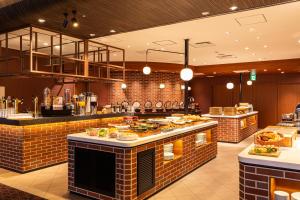 a restaurant with a buffet line with food at Hotel Keihan Kyoto Grande in Kyoto