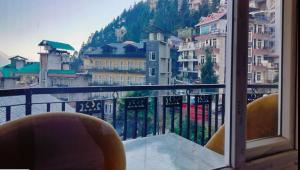 a view of a city from a balcony at Young Monk Hostel Bhagsu,Mcleodganj in Dharamshala