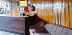 a bar with two chairs in front of a counter at Young Monk Hostel Bhagsu,Mcleodganj in Dharamshala