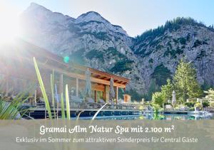 a picture of a building with a mountain in the background at Hotel Central - das kleine Boutique Hotel am Achensee in Pertisau