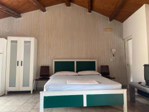 a bedroom with a large bed in a room at Pikaret Bed&Breakfast in Corato