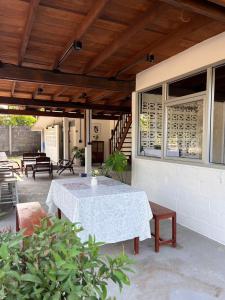 a patio with a white table and chairs and a building at ค้างคาวกินกล้วยโฮมสเตย์ in Ban Mung