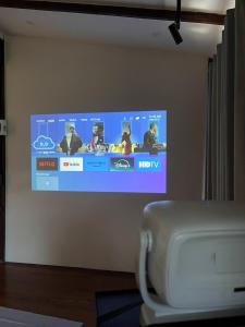 a flat screen tv on a wall in a room at ค้างคาวกินกล้วยโฮมสเตย์ in Ban Mung