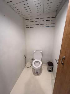a bathroom with a toilet in a room at ค้างคาวกินกล้วยโฮมสเตย์ in Ban Mung +3 photos