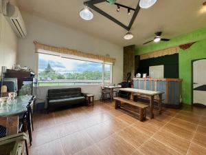 a living room with a couch and a table at Mei Shiou B&B in Dongshan