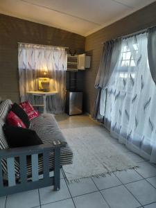 a living room with a couch and a window at Ocean River in Gqeberha