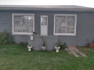 a house with two toilets in front of it at Ocean River in Gqeberha