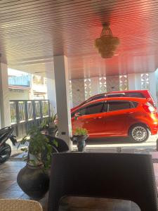 a red car is parked in a garage at Balay Buenavista in Magdalena