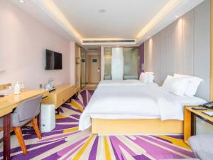 a hotel room with a large bed and a desk at Lavande Hotel Xi'an Bell Tower in Xi'an